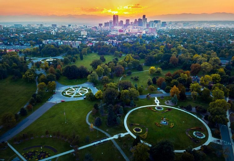 Aerial photo of Denver skyline at sunset taken from a park